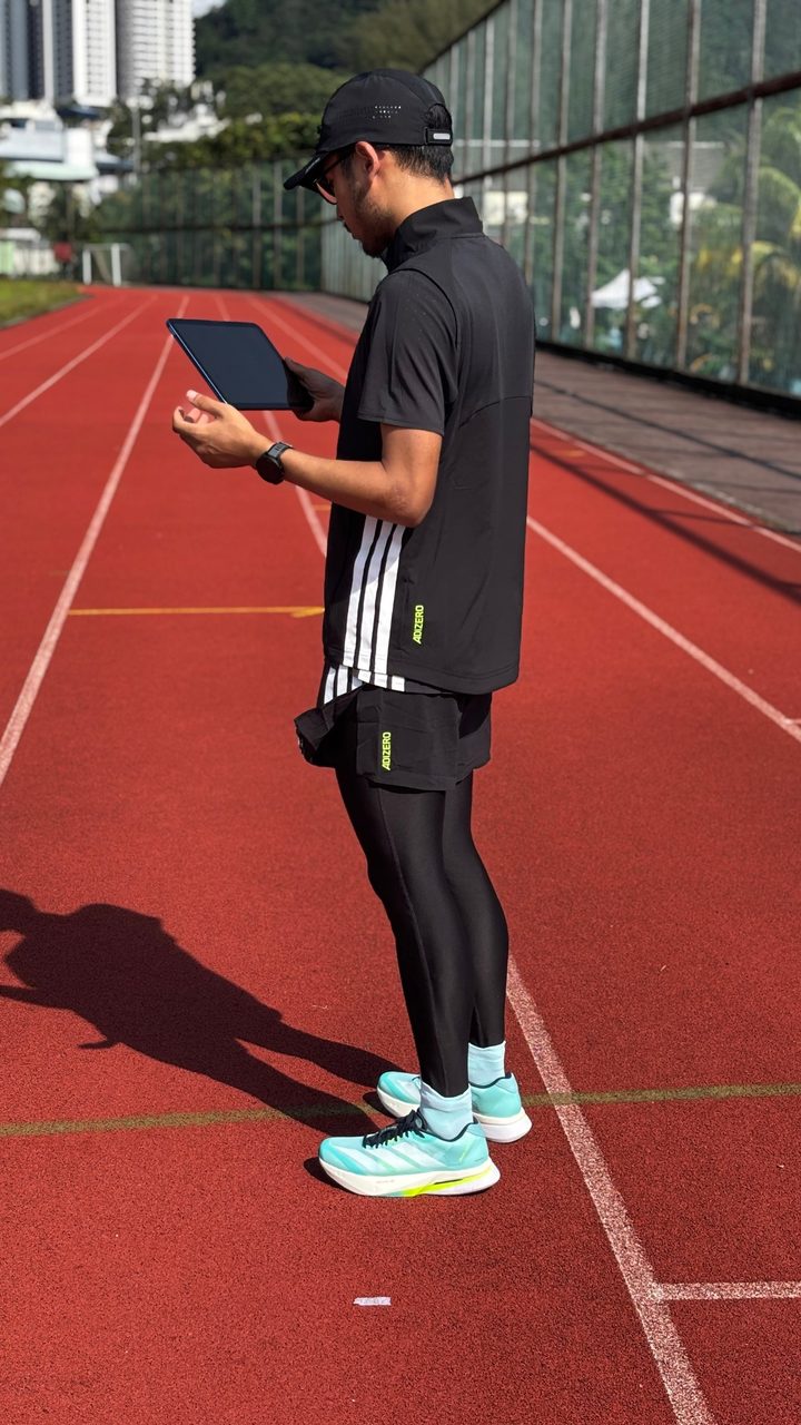 Haziq on a running track in Adidas Adizero kit and Boston 13 shoes